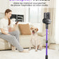 Woman using a smartphone with a dog sitting on the floor next to a vacuum cleaner in a living room.