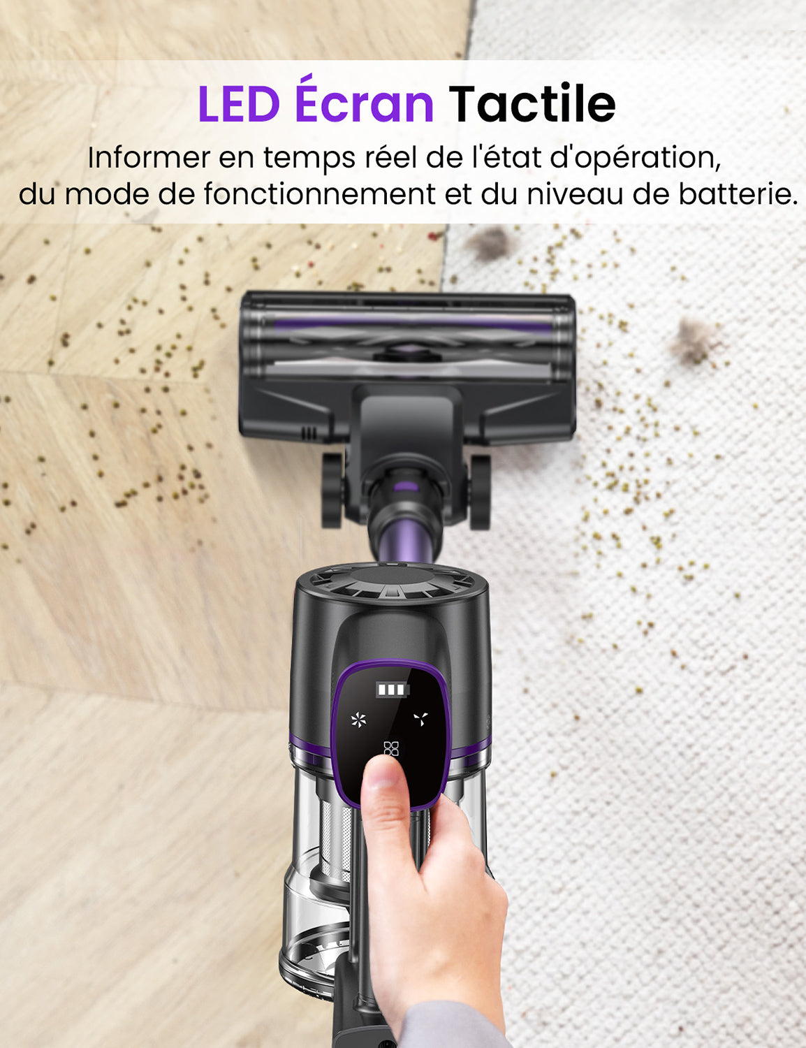 Hand holding a vacuum cleaner with LED touch panel on a wooden floor.