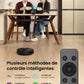 Two people sitting at a table with a robot vacuum cleaner and remote control, featuring smart control methods.