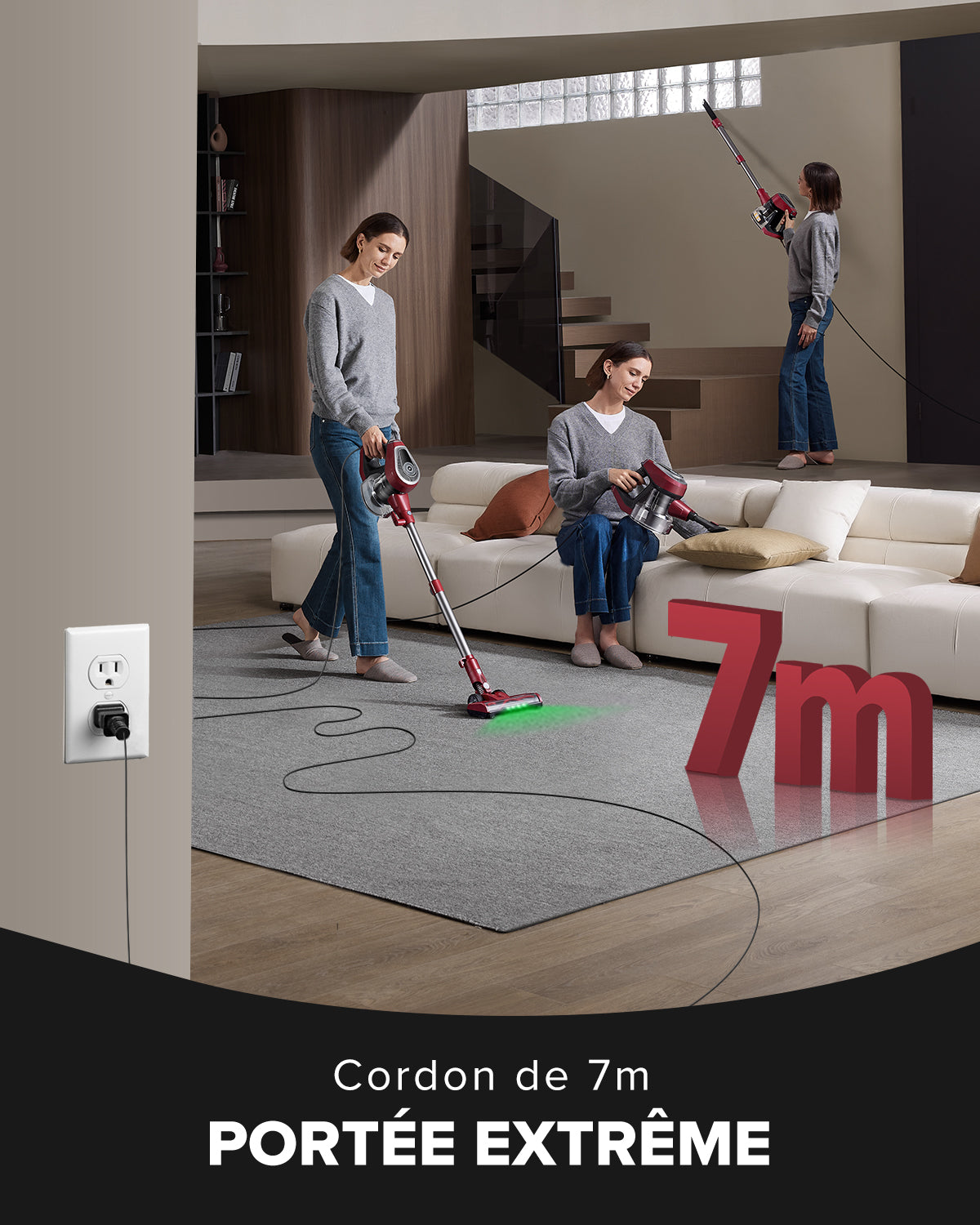 Two people using a vacuum cleaner with a 7m cord in a living room setting.