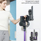 Woman using a vacuum cleaner with a storage wall mount in a living room.